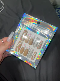 a person holding a bag of holographic nails