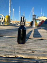 a bottle of essential oil sitting on a dock