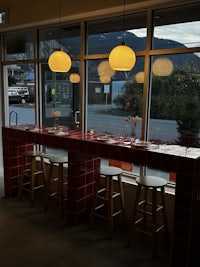 a restaurant with a table and chairs in front of a window