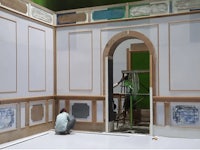 a man is painting a room with white walls