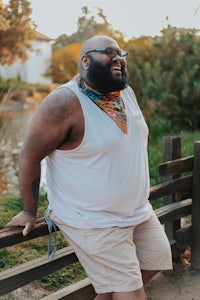 a man with a beard sitting on a bench