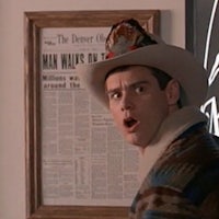 a man in a cowboy hat standing in front of a newspaper