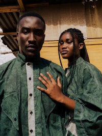 a man and woman in green clothing standing next to each other