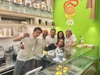 a group of people posing in front of a counter