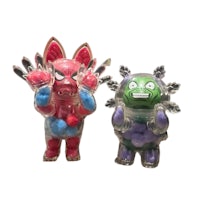 a pair of plastic figurines with a face on them
