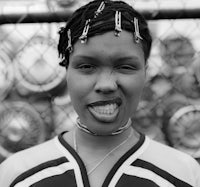 a black and white photo of a woman with her tongue out