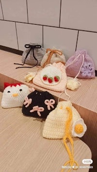 a group of crocheted bags on a table