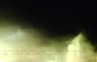 an image of a fountain in the dark with smoke coming out of it