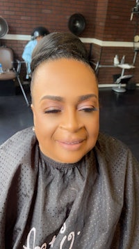 a woman smiling in a hair salon