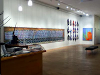 an art gallery with several paintings on the wall