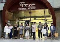 a group of people standing in front of a building