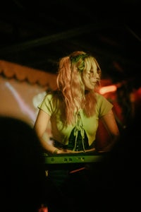 a woman playing a keyboard in front of a crowd