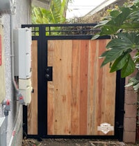 a wooden gate with a black metal frame