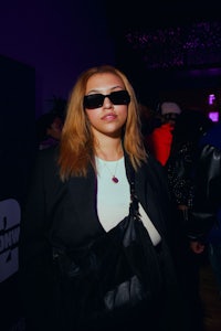 a woman wearing sunglasses at a party