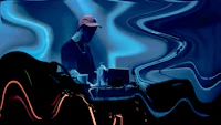 a man in a hat is sitting in front of a blue light