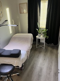 a room with a massage table and a chair