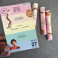 a person is holding a ticket with two waffles on it
