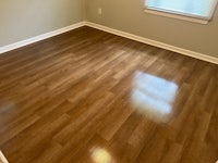 a room with hardwood floors and a window