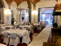 a banquet room with white tables and chairs