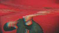 a person is standing in front of a red wall