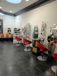 a hair salon with many chairs and tables