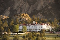 a large white building sits on top of a mountain