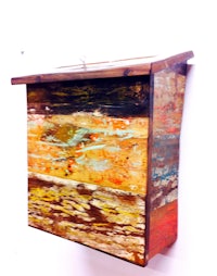 a wooden bird box on a wall