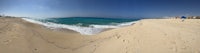 a fish eye view of a beach with waves and sand