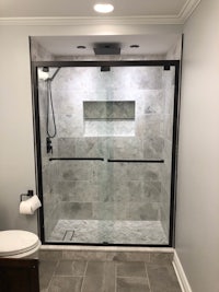 a bathroom with a glass shower door and toilet
