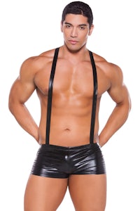 a man in black leather suspenders posing for a photo
