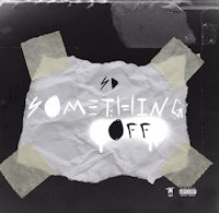 the cover of something off, with a piece of tape on it
