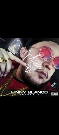 an image of a man wearing sunglasses and pointing at a car