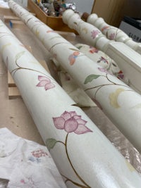 a pair of bed legs with floral designs painted on them