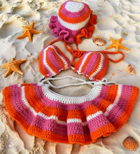 an orange and pink crocheted bikini set on the sand