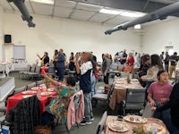 a large group of people sitting at tables in a room