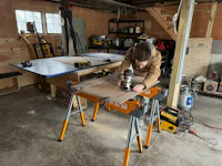 a man working on a table saw in a garage