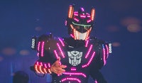 a man in a robot costume standing in front of a stage