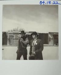 a photo of two men standing next to each other