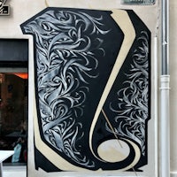 a black and white mural on the side of a building