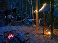 a group of people camping in the woods at night