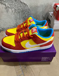 the nike sb dunk low is on top of a purple box