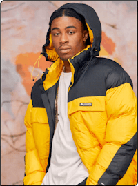 a young man wearing a yellow and black down jacket