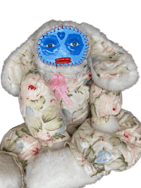 a stuffed animal with a blue face