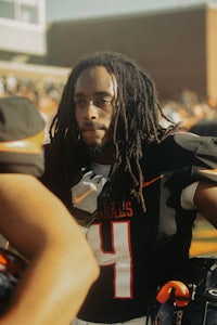 a football player with dreadlocks