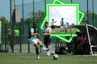a soccer player kicking a soccer ball