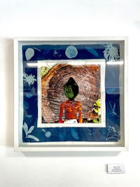 a framed photo of a person in a blue frame