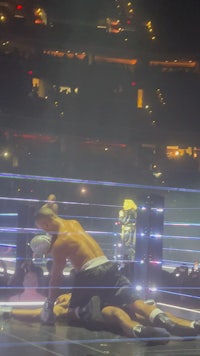 a man is laying on the ground in a boxing ring