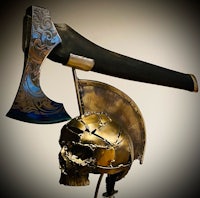 an axe with a skull on top of it