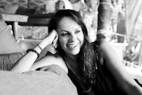 a black and white photo of a woman sitting on a couch