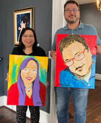 a man and a woman holding up portraits in a living room